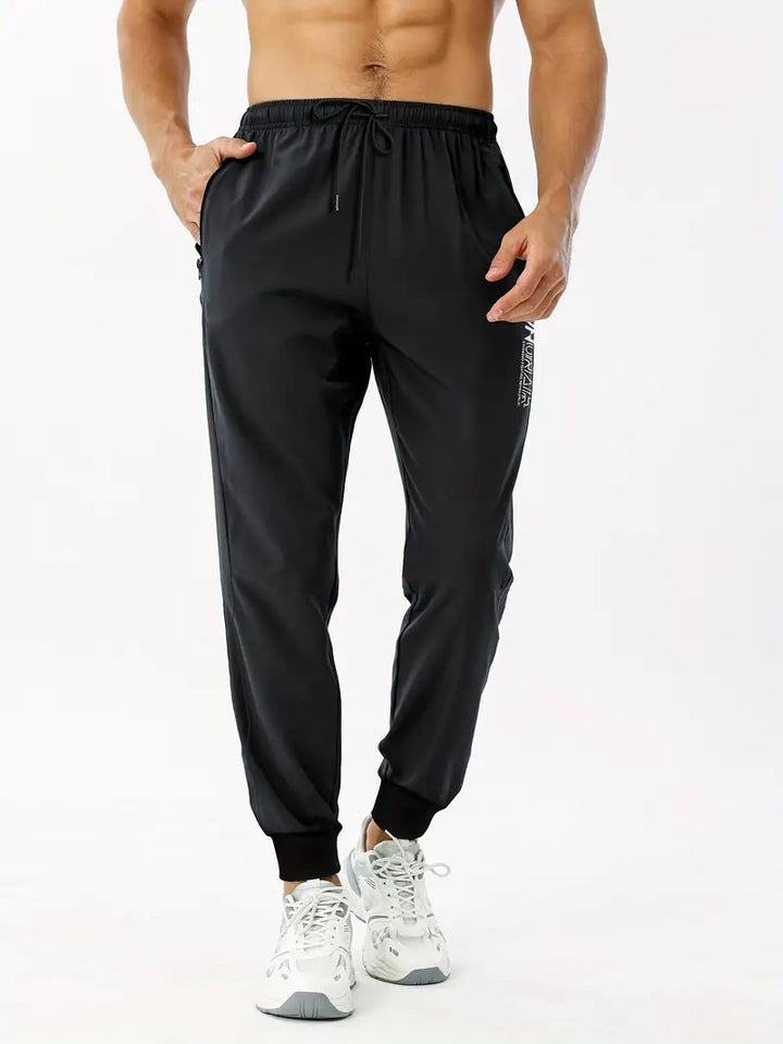 Joggers med bokstavstryck och fickor med dragkedja
